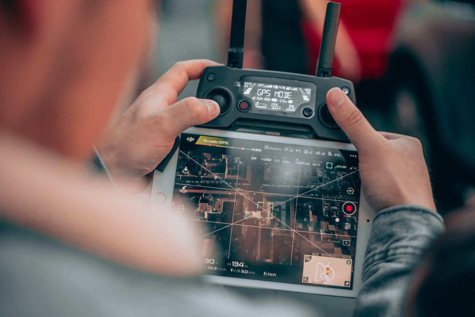 Hands operating a drone remote controller